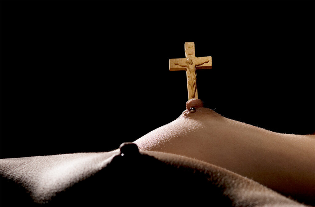cross atop a woman's nipple